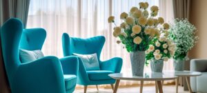 ターコイズカラーのソファと生けられた花